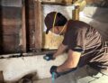 image of a person using a concrete meter to determine the water levels and how dry a structural wall is after water damage